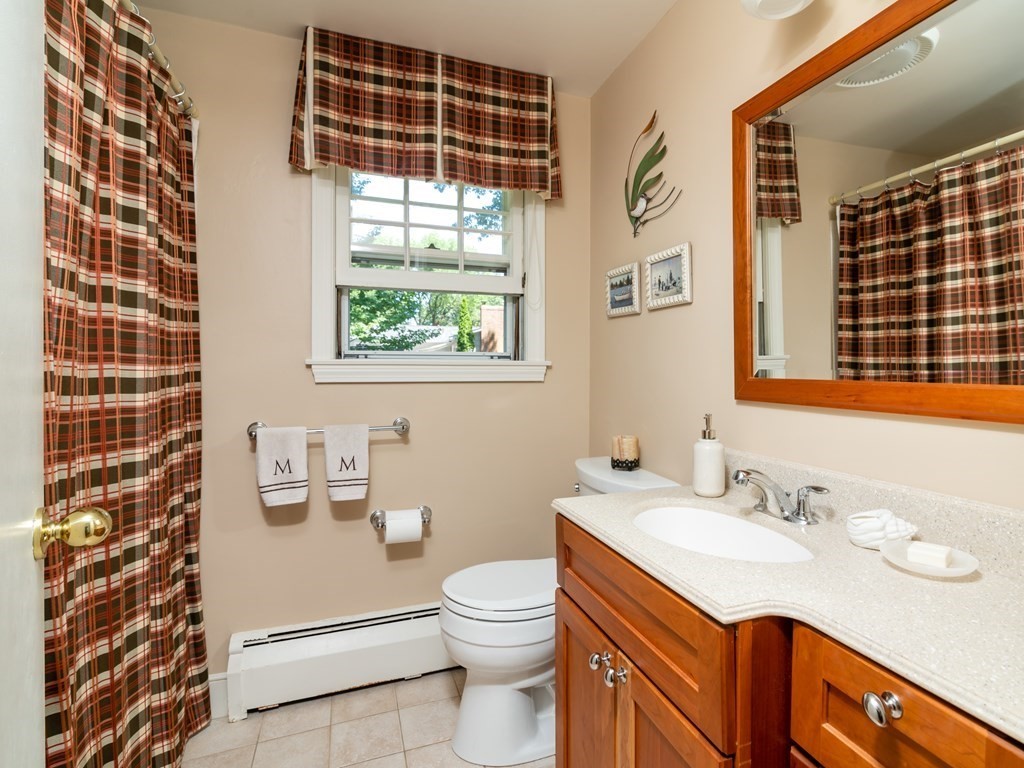 17 Winthrop Road Hingham, MA 02043 - Photo 13 of 27 a bathroom with a granite countertop sink toilet a mirror and shower