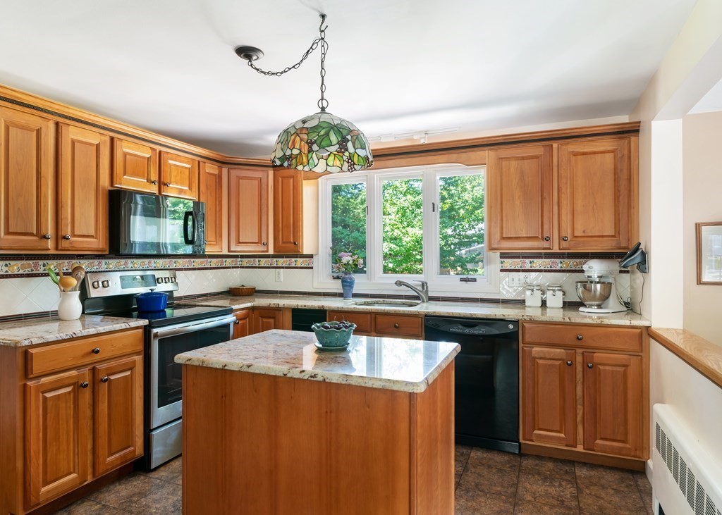 17 Winthrop Road Hingham, MA 02043 - Photo 6 of 27 a kitchen with stainless steel appliances granite countertop a sink a stove cabinets and a counter top space