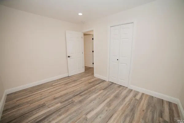a view of an empty room and wooden floor