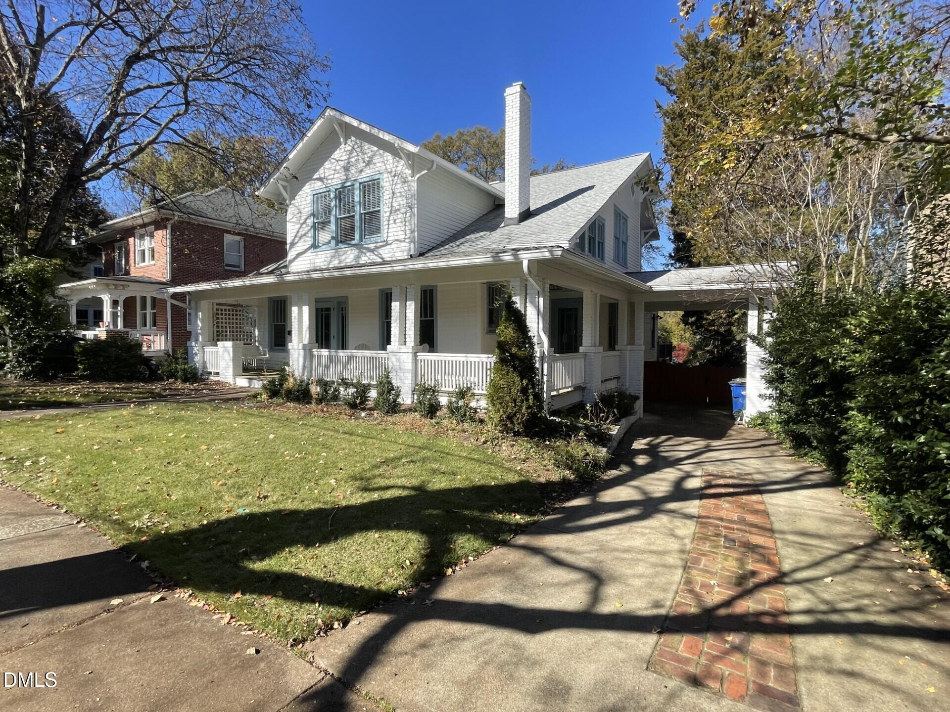 a front view of house with yard and trees around