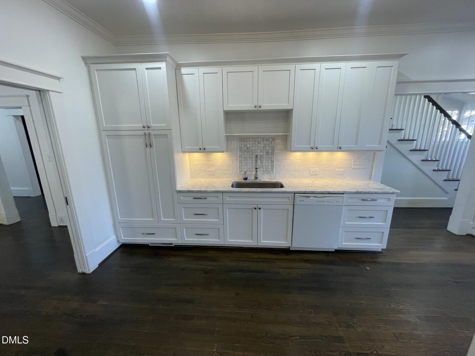 313 Calvin Road Raleigh, NC 27605 - Photo 13 of 39 a view of kitchen with granite countertop white cabinets and black appliances