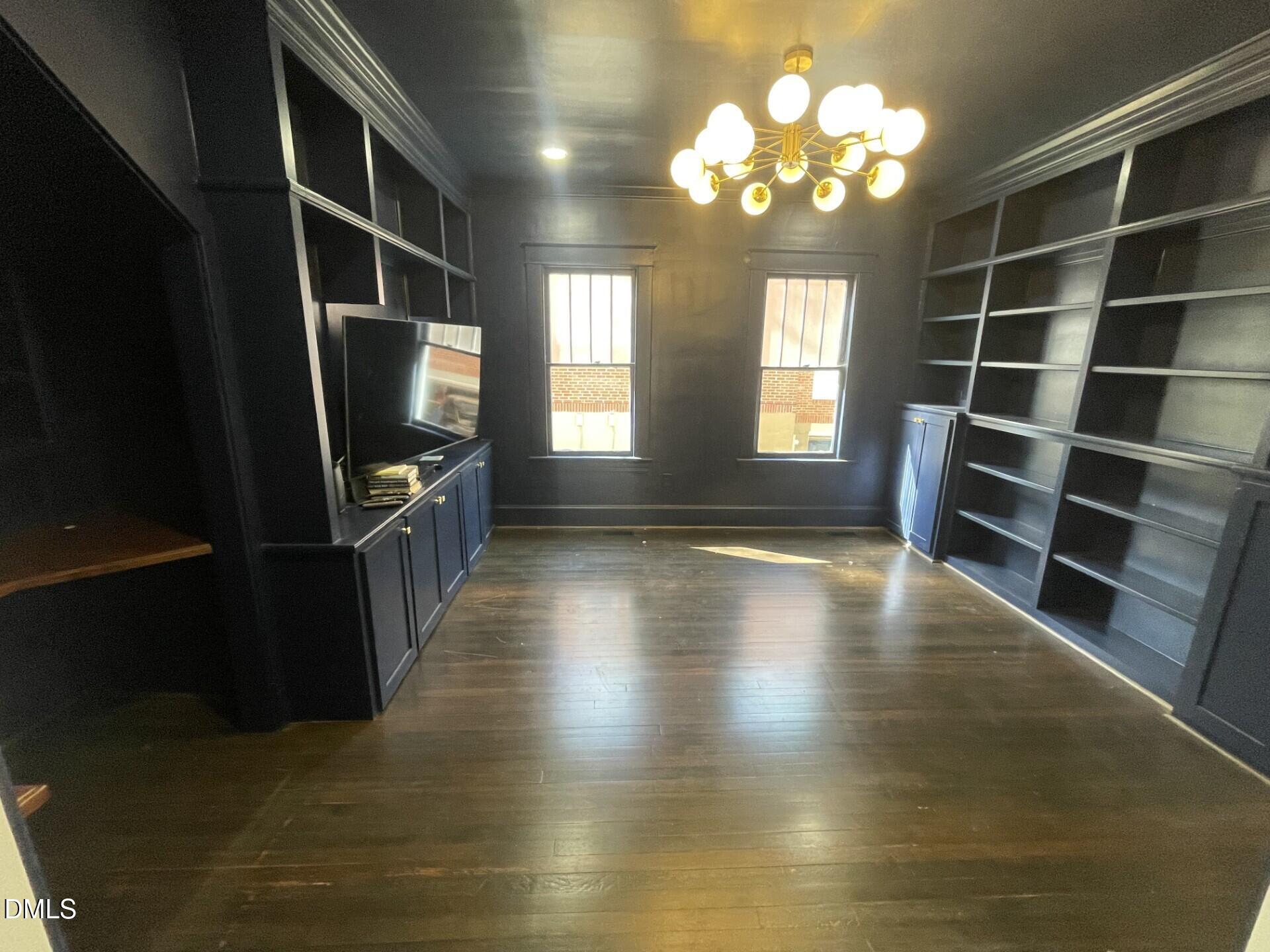 313 Calvin Road Raleigh, NC 27605 - Photo 15 of 39 a view of a livingroom with furniture window and wooden floor