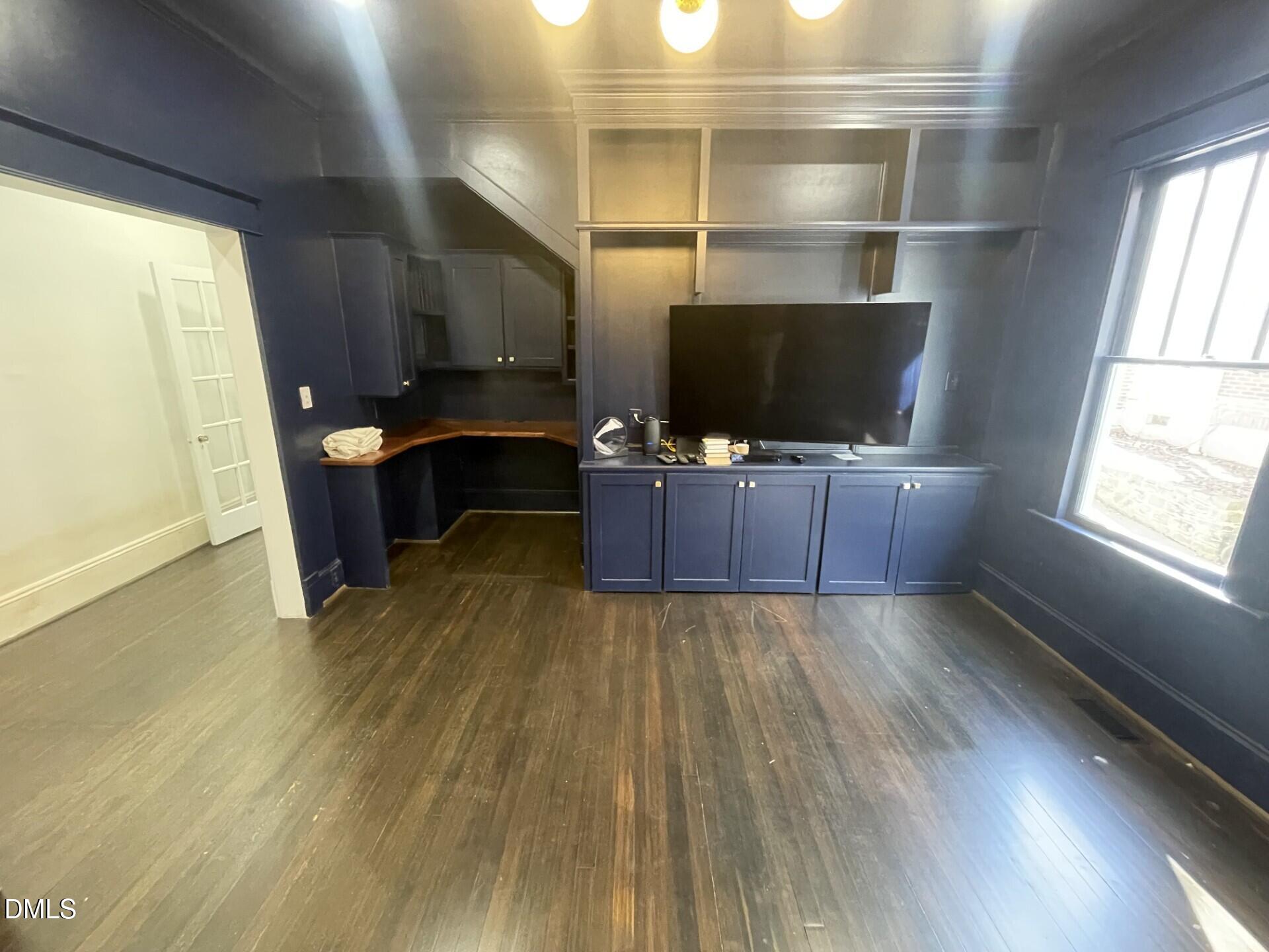 313 Calvin Road Raleigh, NC 27605 - Photo 16 of 39 a living room with furniture and a flat screen tv