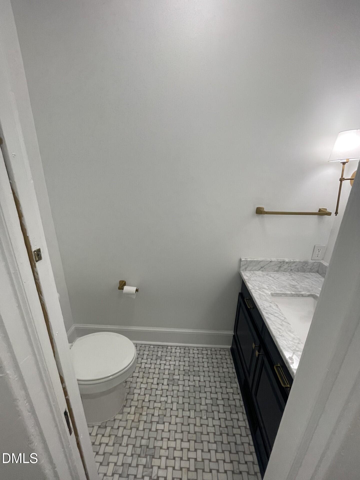 313 Calvin Road Raleigh, NC 27605 - Photo 18 of 39 a bathroom with a granite countertop shower and a toilet