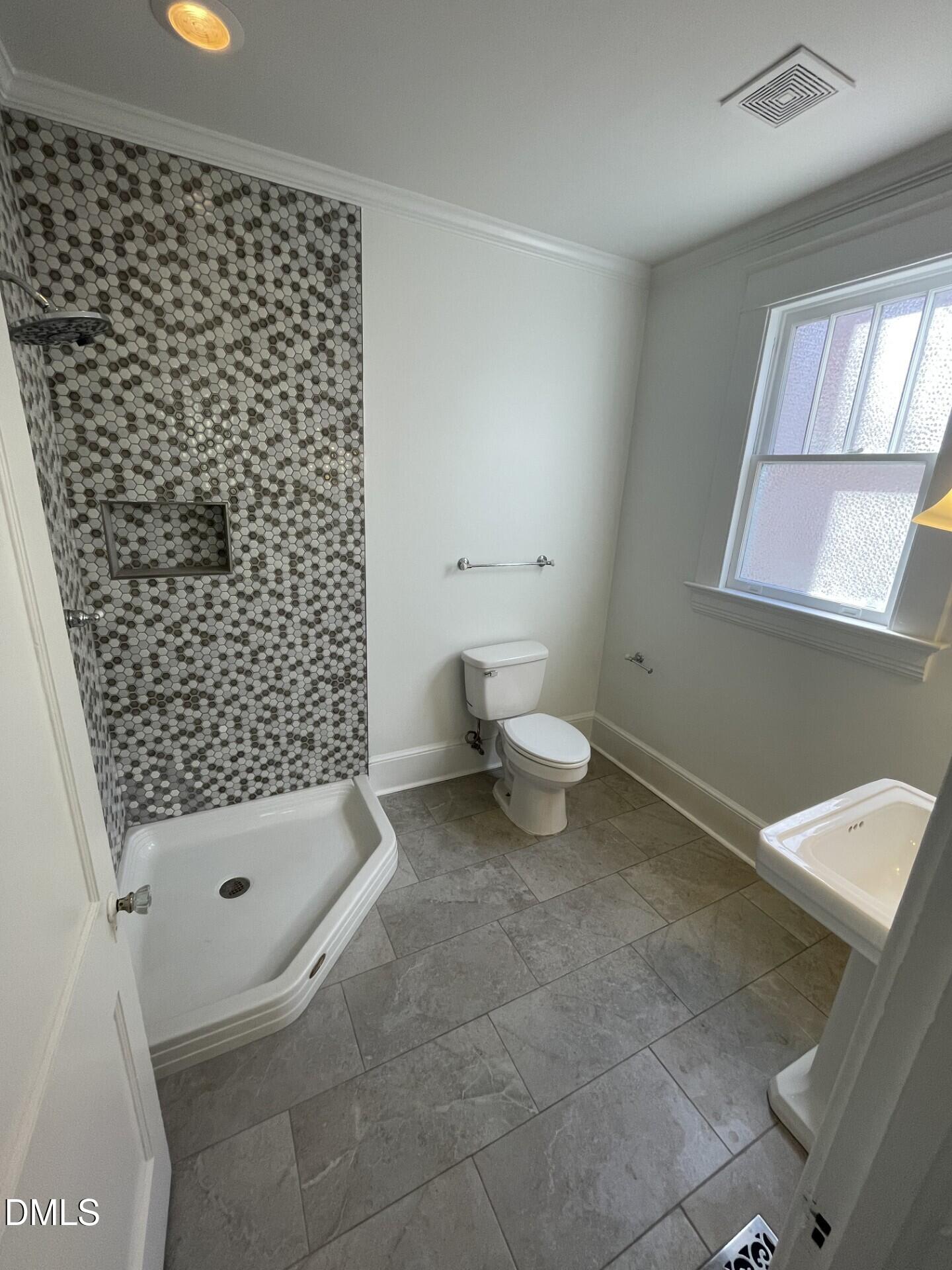 313 Calvin Road Raleigh, NC 27605 - Photo 21 of 39 a bathroom with a toilet and a shower