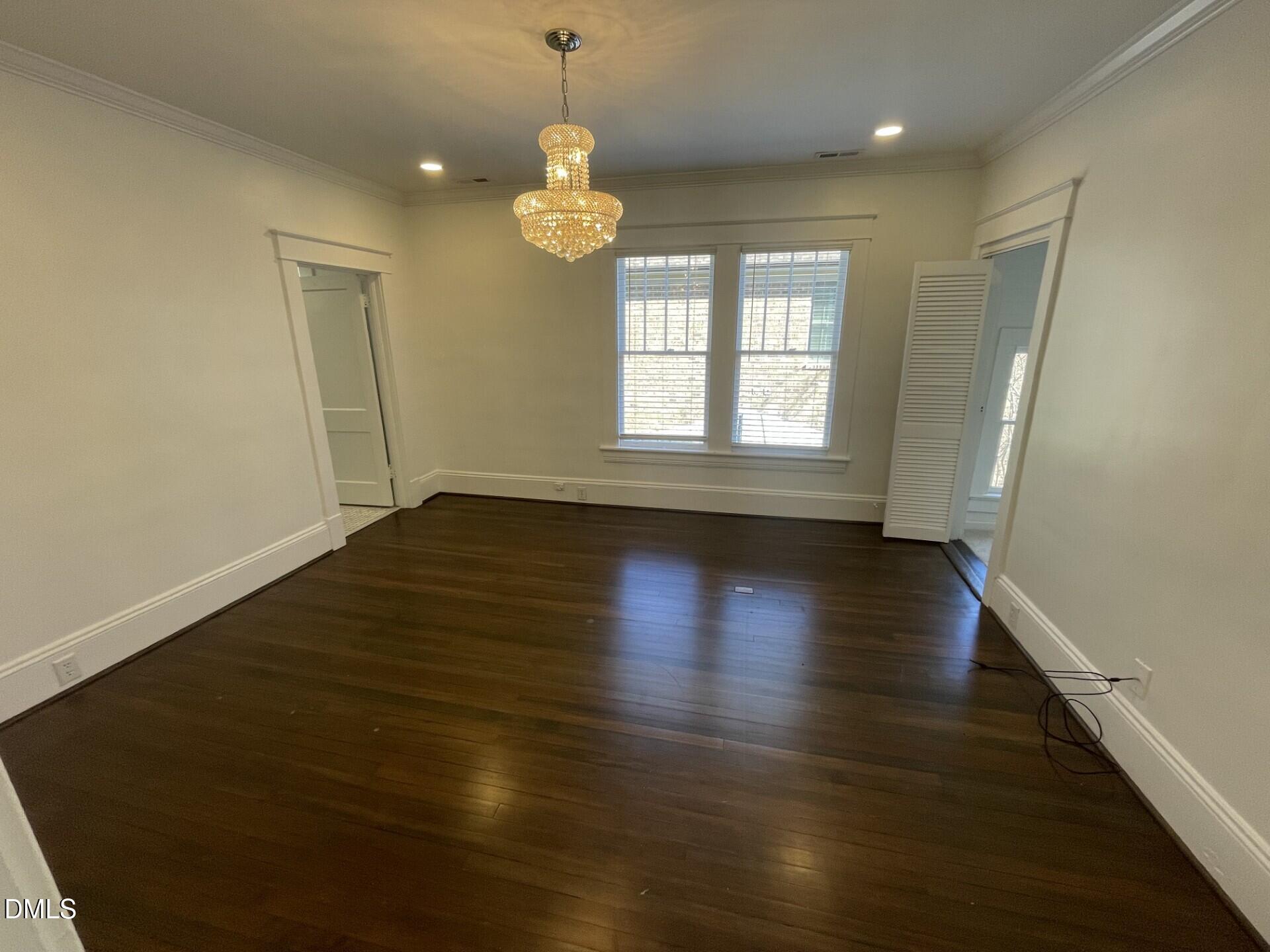313 Calvin Road Raleigh, NC 27605 - Photo 31 of 39 an empty room with wooden floor and window