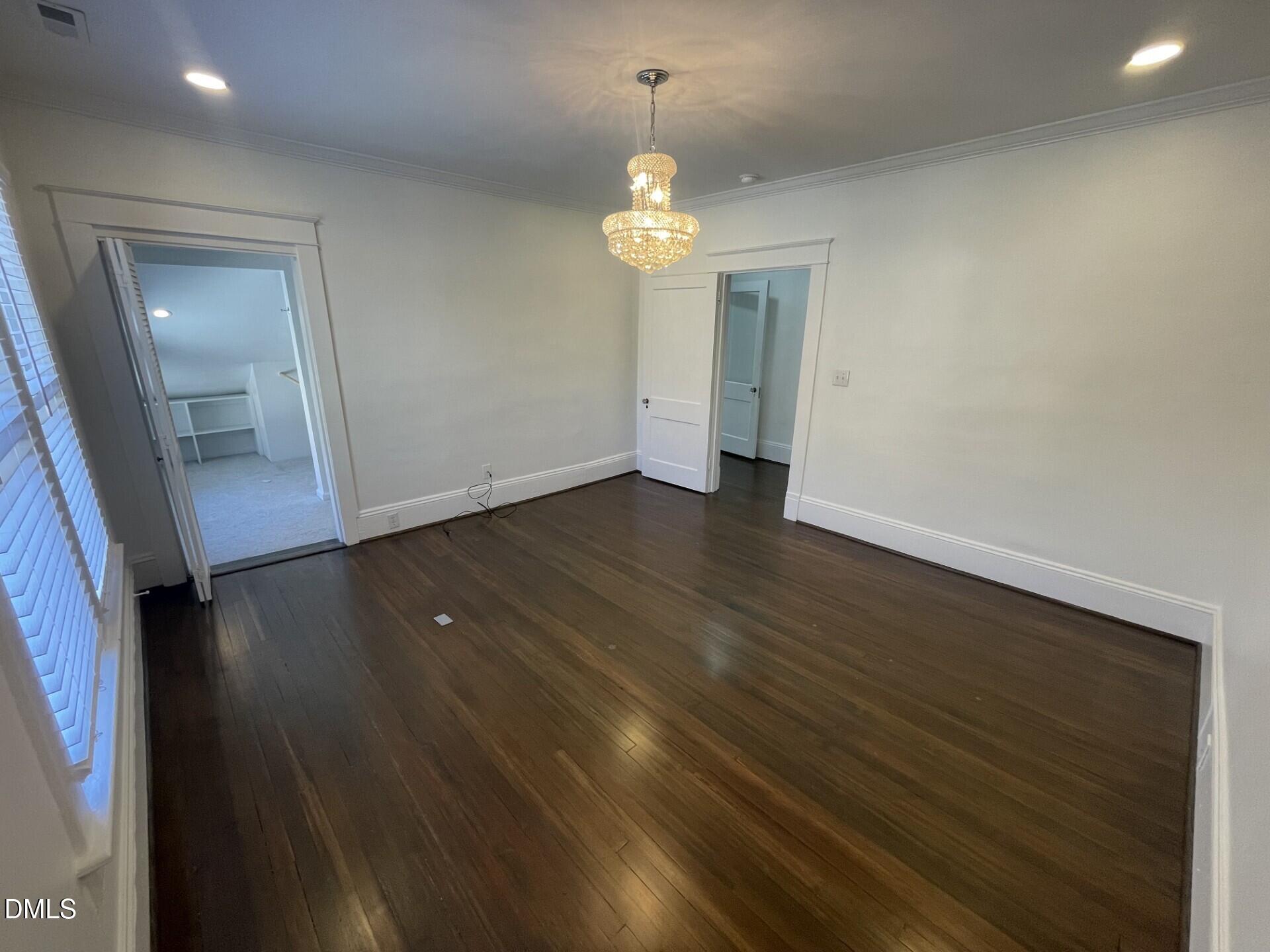 313 Calvin Road Raleigh, NC 27605 - Photo 33 of 39 wooden floor in an empty room with a window