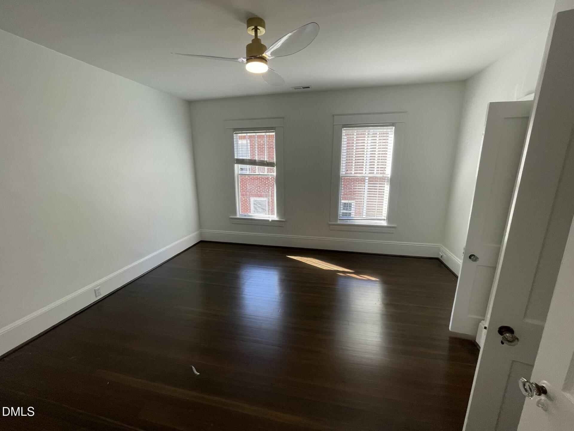313 Calvin Road Raleigh, NC 27605 - Photo 35 of 39 an empty room with wooden floor and windows