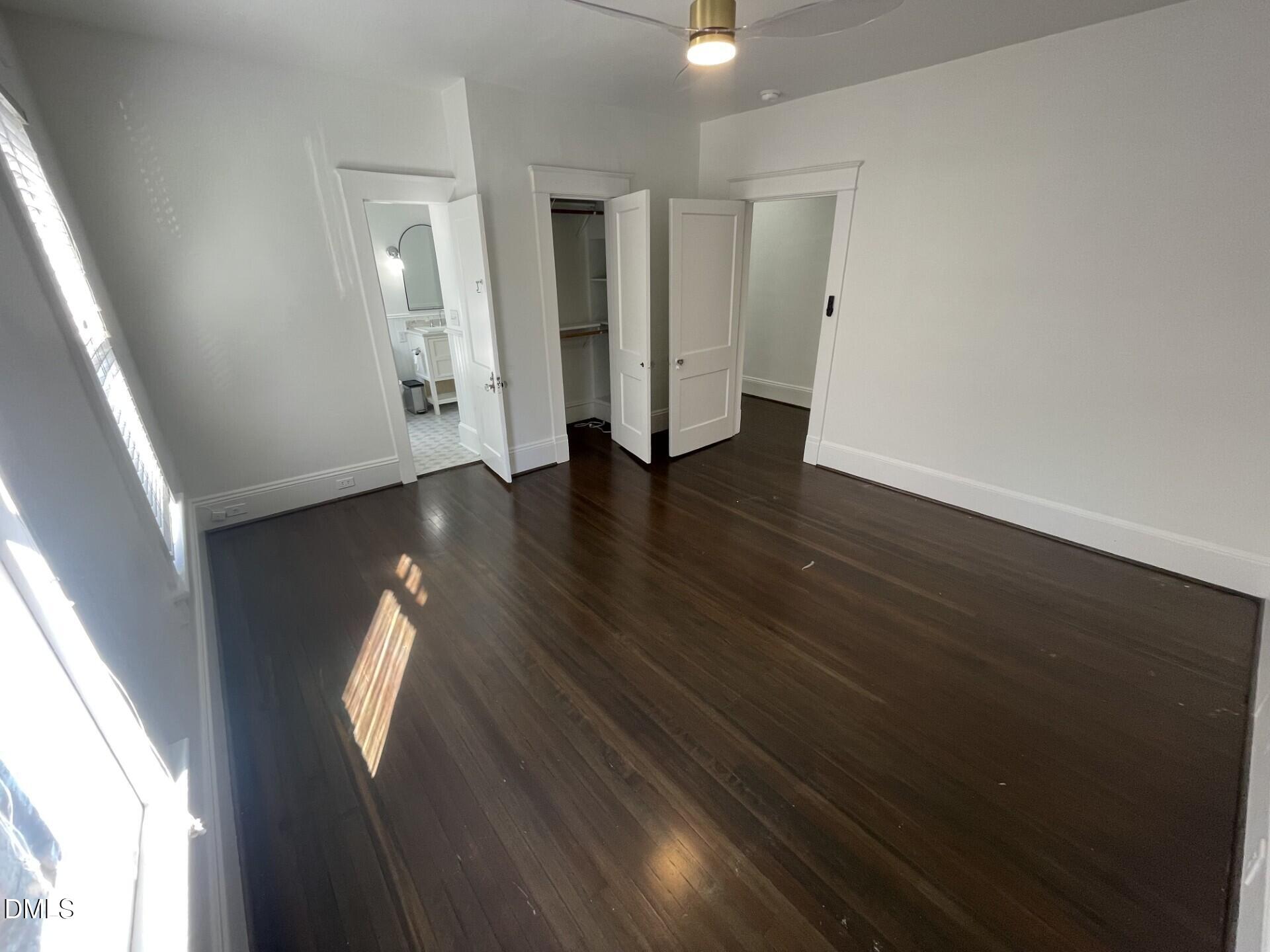 313 Calvin Road Raleigh, NC 27605 - Photo 36 of 39 an empty room with wooden floor and windows