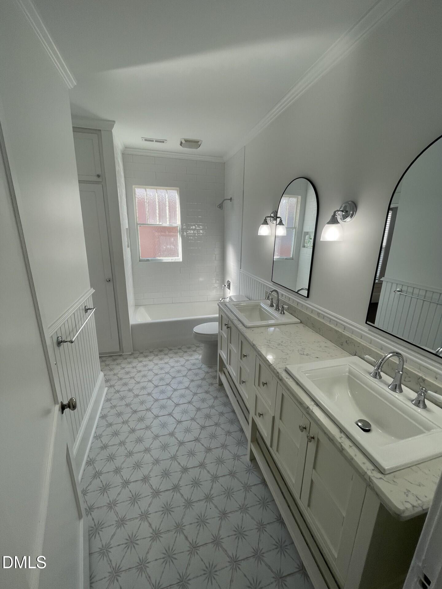 313 Calvin Road Raleigh, NC 27605 - Photo 38 of 39 a bathroom with a sink a vanity and mirror