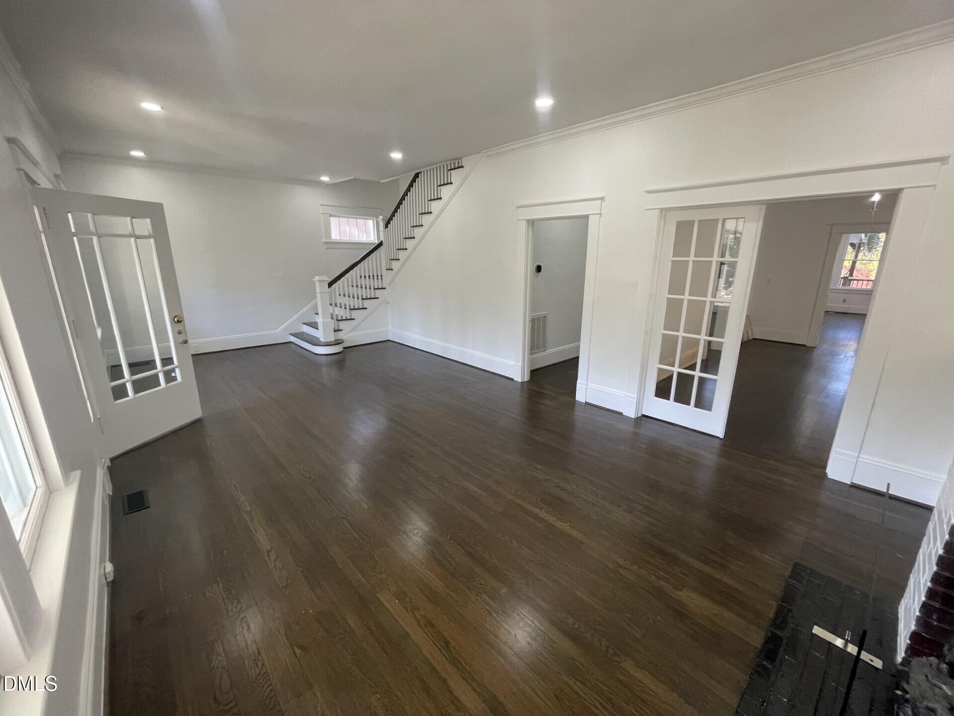 313 Calvin Road Raleigh, NC 27605 - Photo 6 of 39 a view of a livingroom with wooden floor and stairs
