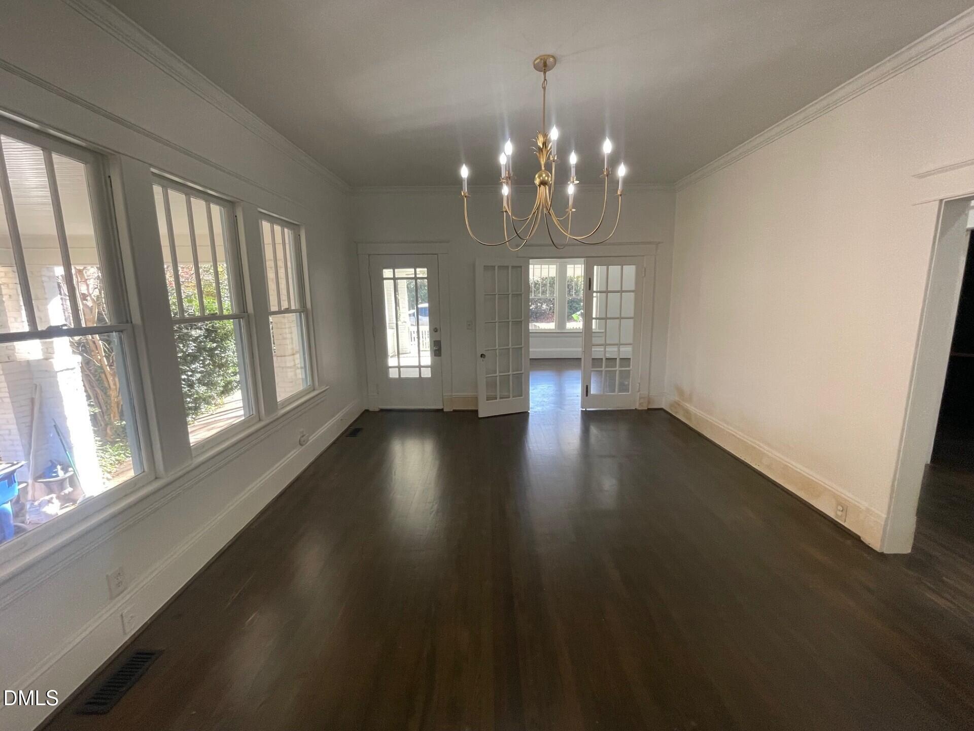 313 Calvin Road Raleigh, NC 27605 - Photo 10 of 39 wooden floor in an empty room with a window