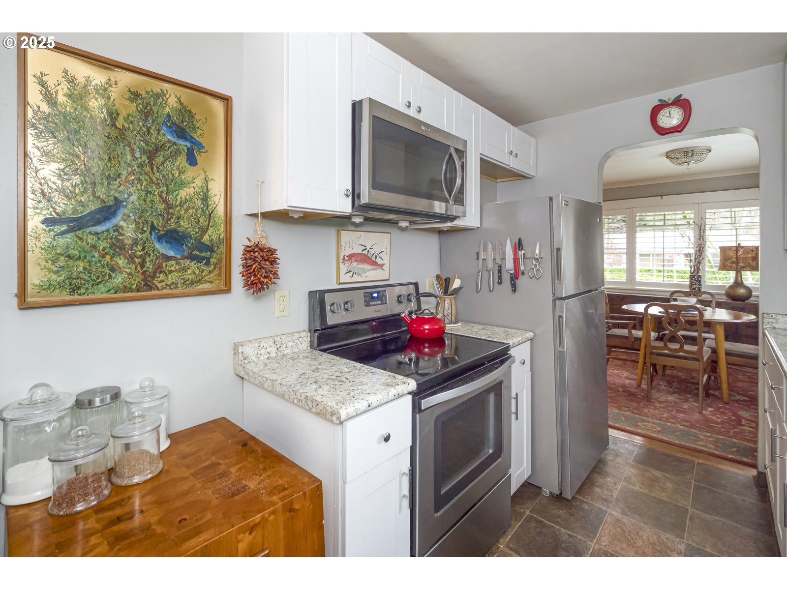 6125 Southeast 138th Place Portland, OR 97236 - Photo 11 of 32 a kitchen with stainless steel appliances granite countertop a stove a sink and a microwave