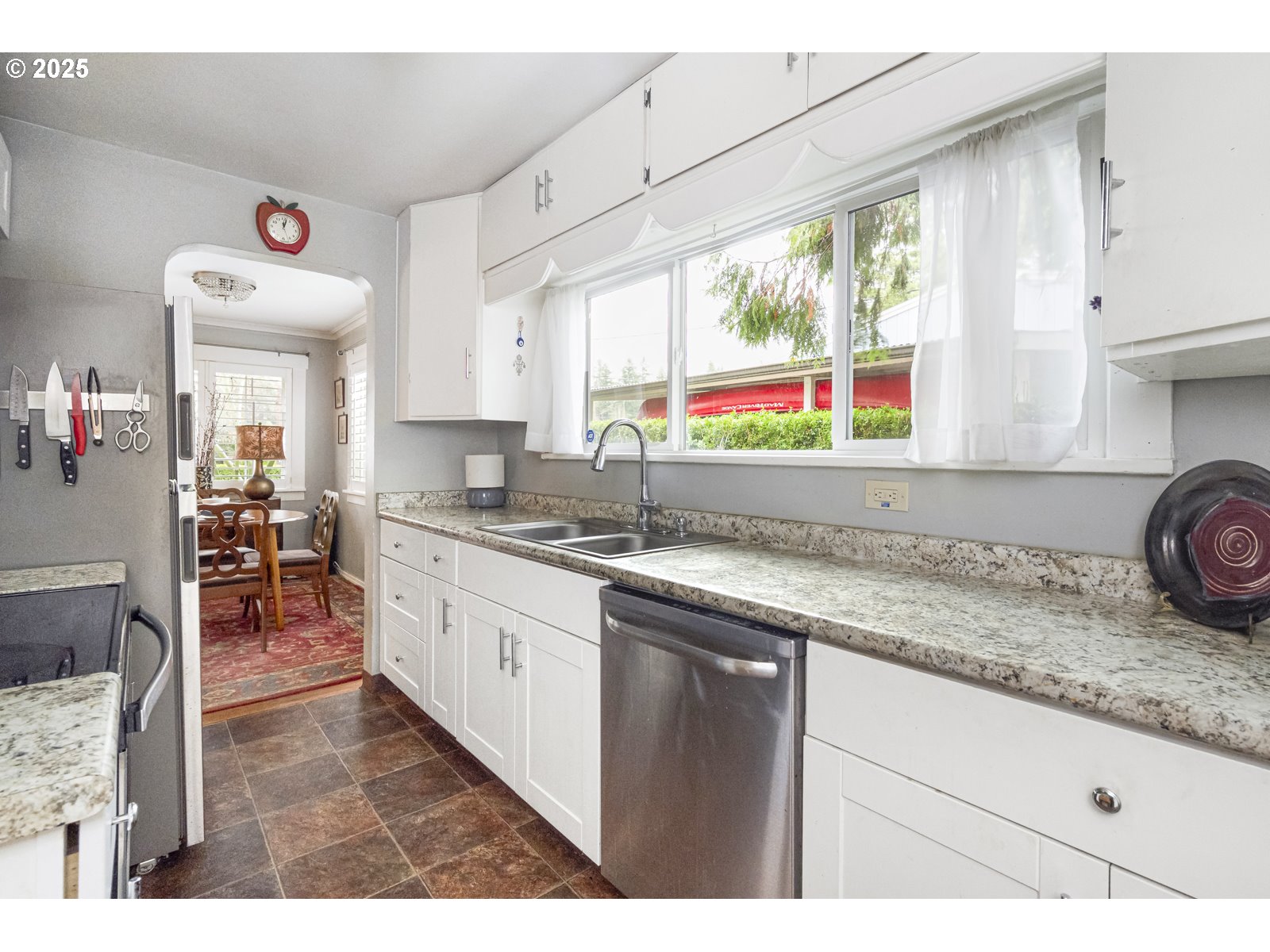 6125 Southeast 138th Place Portland, OR 97236 - Photo 12 of 32 a kitchen with stainless steel appliances granite countertop sink window and cabinets