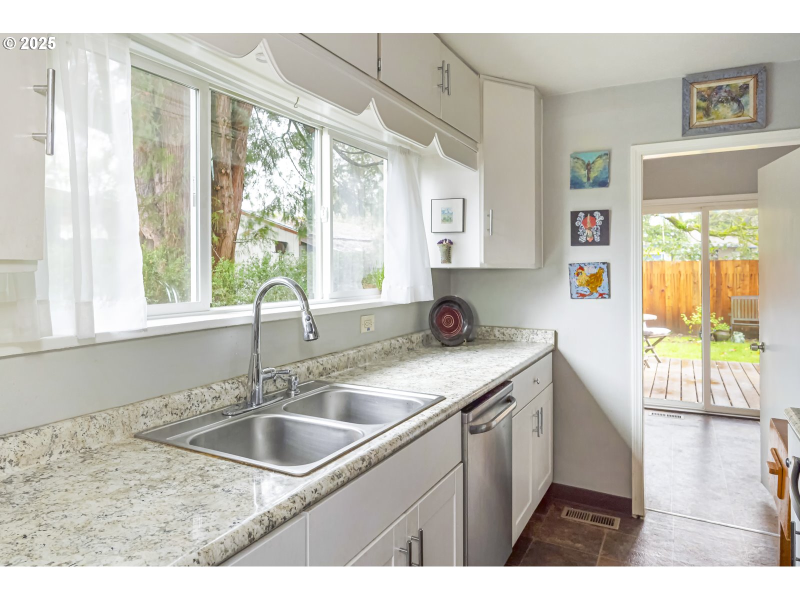 6125 Southeast 138th Place Portland, OR 97236 - Photo 13 of 32 a kitchen with a sink stove and cabinets