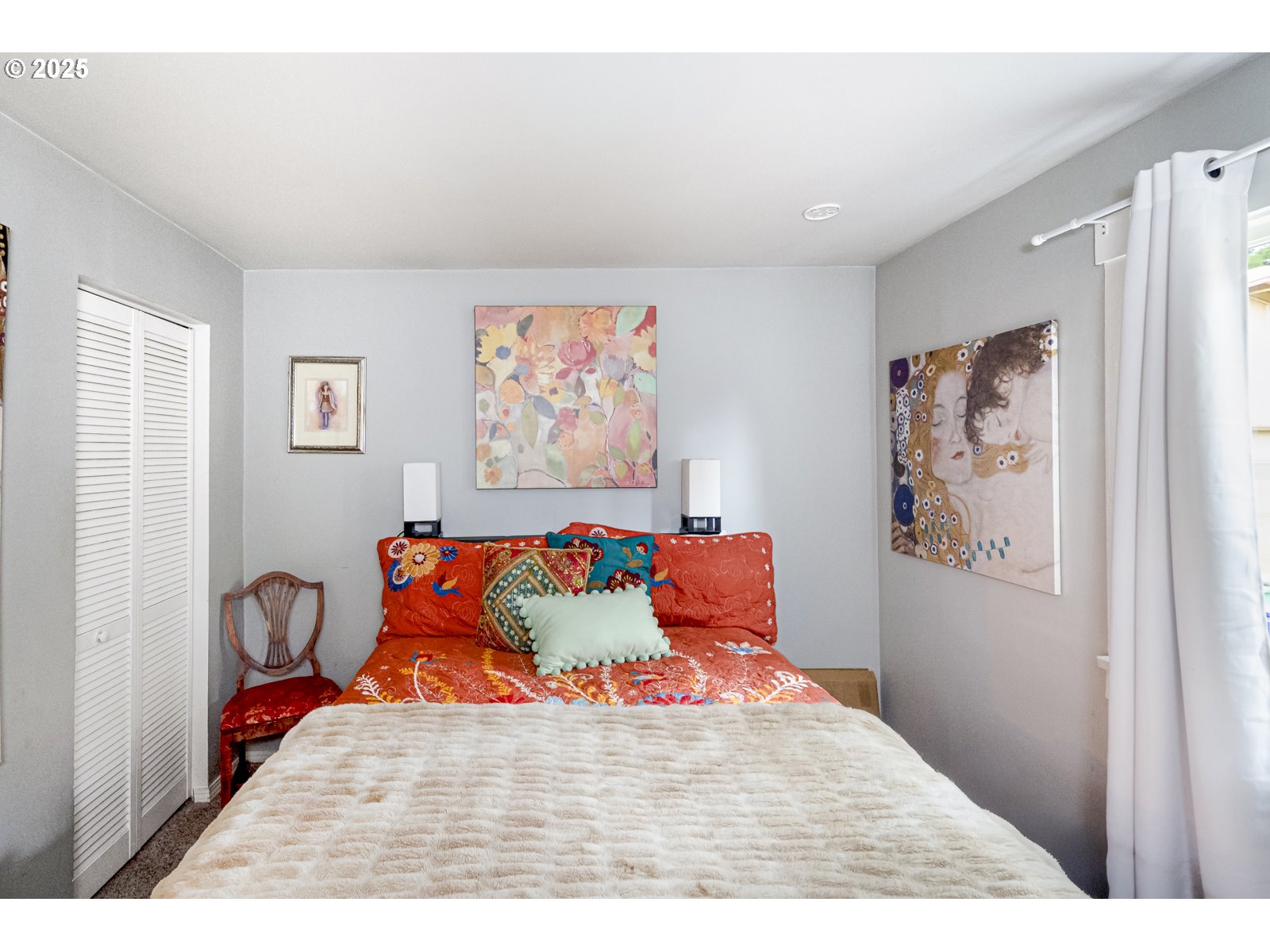 6125 Southeast 138th Place Portland, OR 97236 - Photo 17 of 32 a bed sitting in a bedroom and painting on the wall