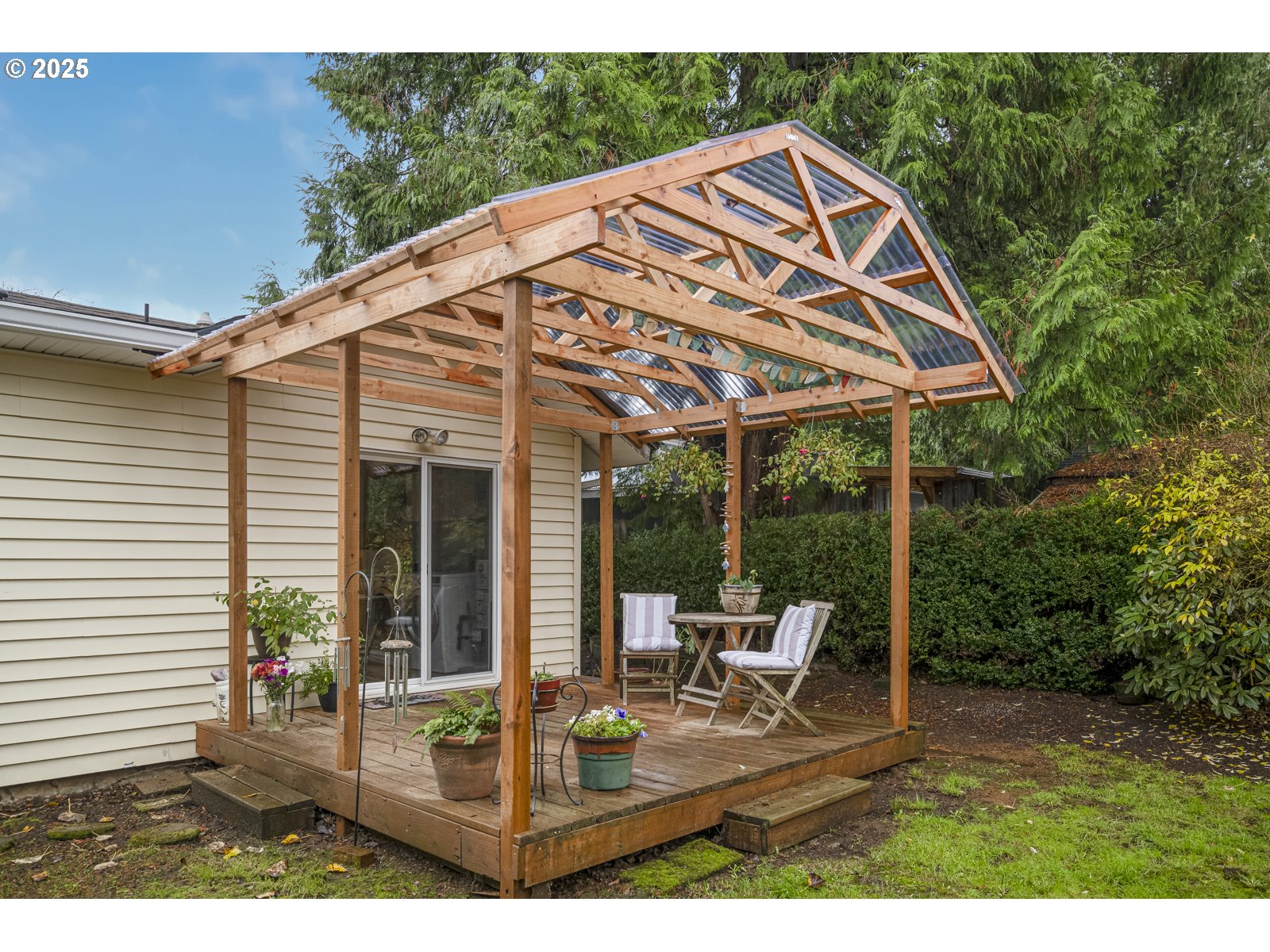 6125 Southeast 138th Place Portland, OR 97236 - Photo 26 of 32 a view of a patio with table and chairs under an umbrella