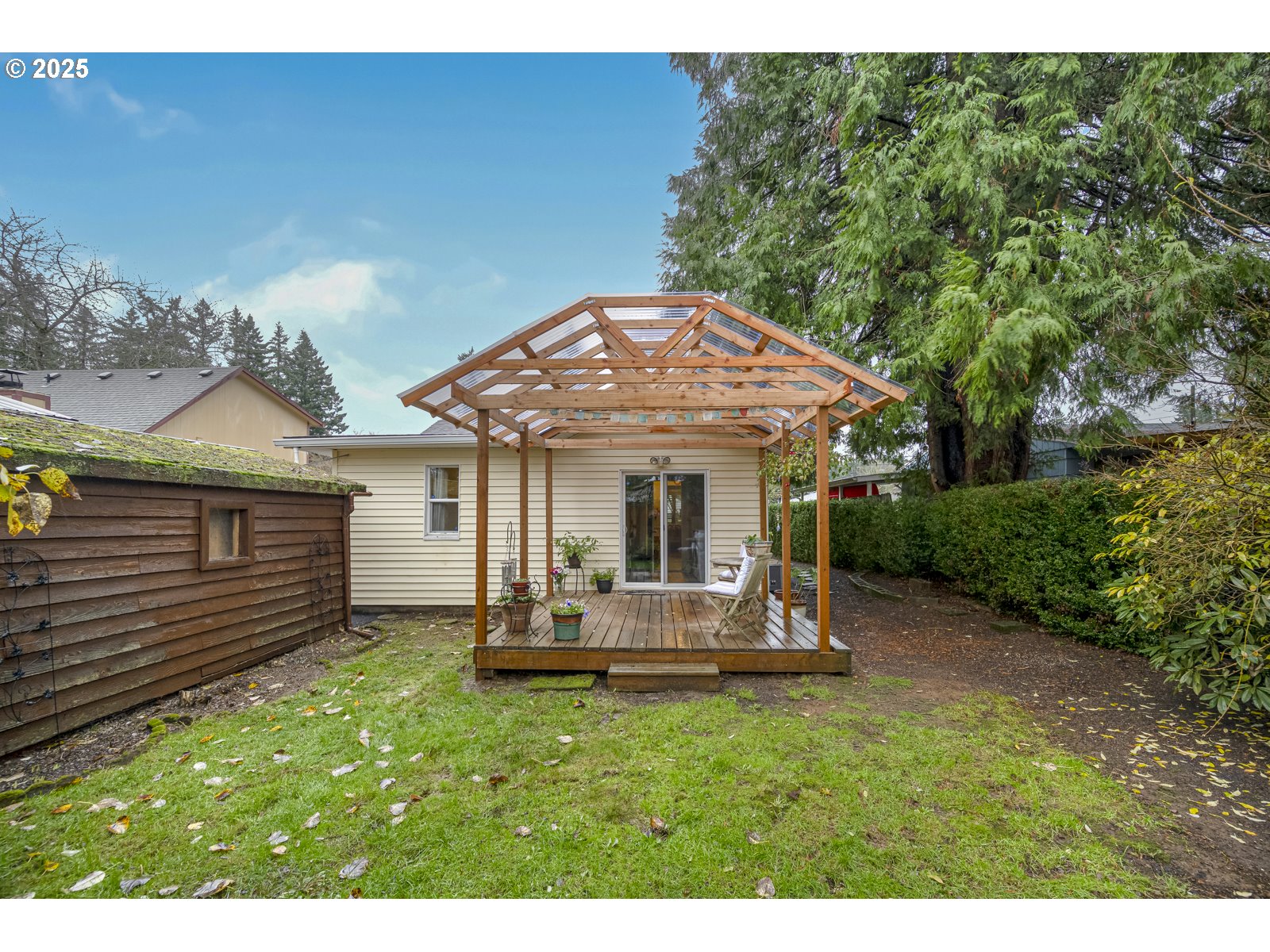 6125 Southeast 138th Place Portland, OR 97236 - Photo 27 of 32 a view of a chair and table in backyard of the house