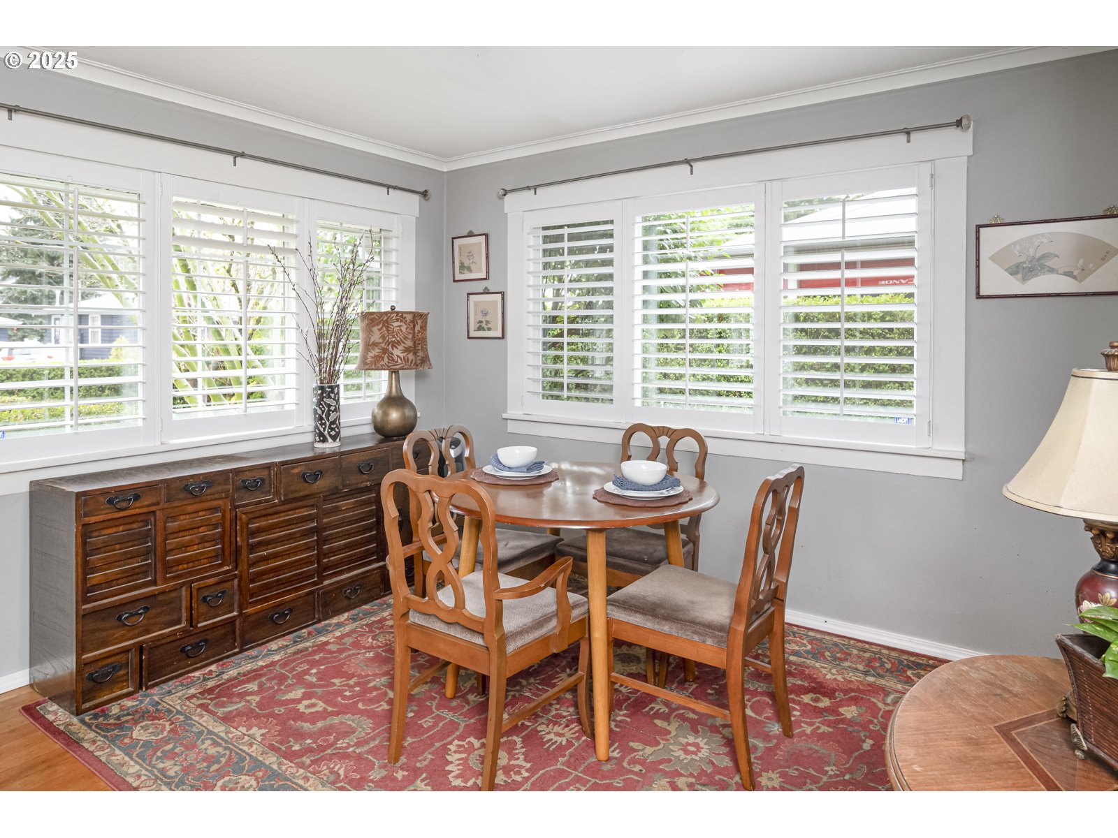 6125 Southeast 138th Place Portland, OR 97236 - Photo 7 of 32 a dining room with furniture a rug and wooden floor