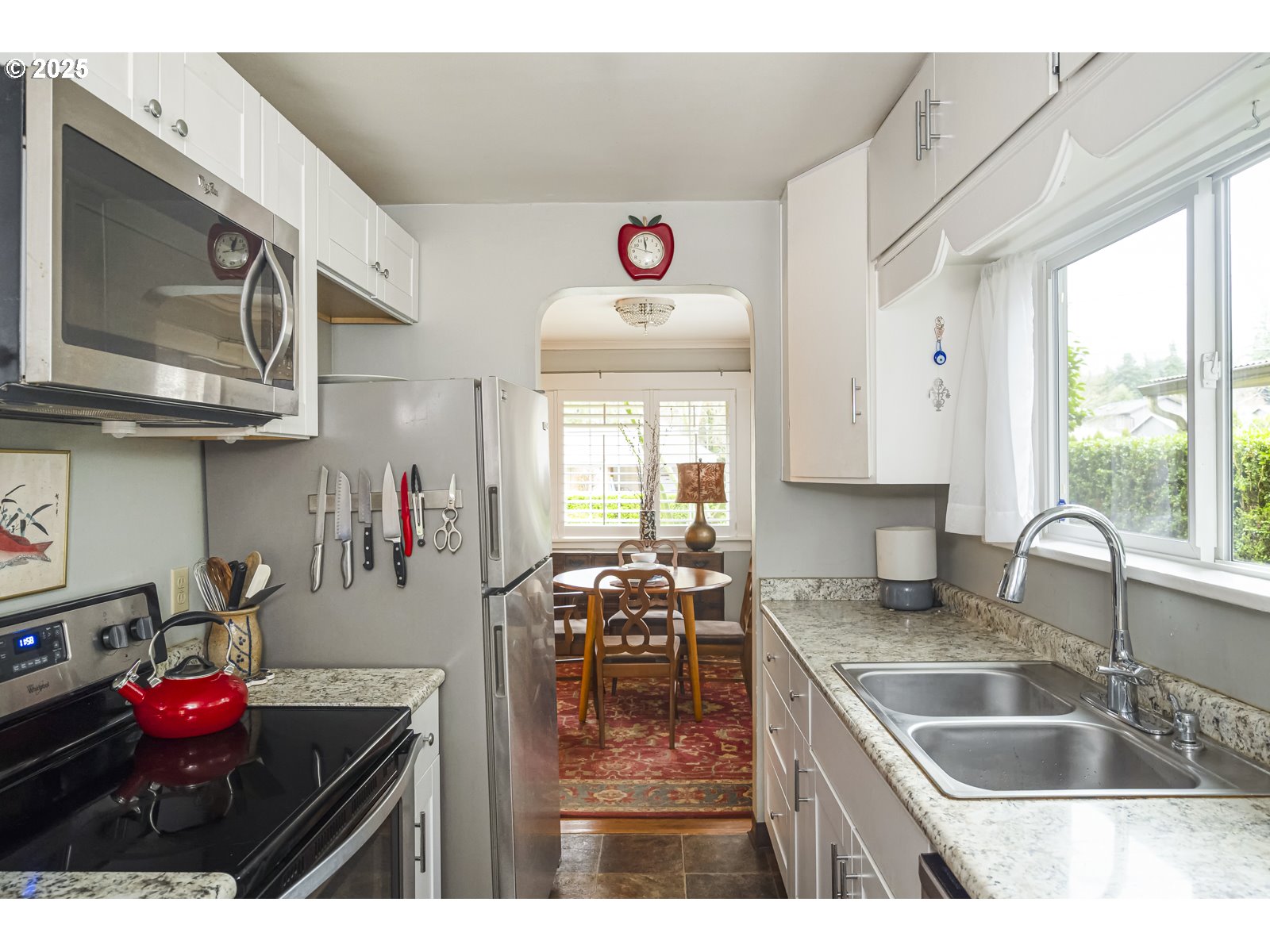 6125 Southeast 138th Place Portland, OR 97236 - Photo 10 of 32 a kitchen with cabinets a stove and a sink