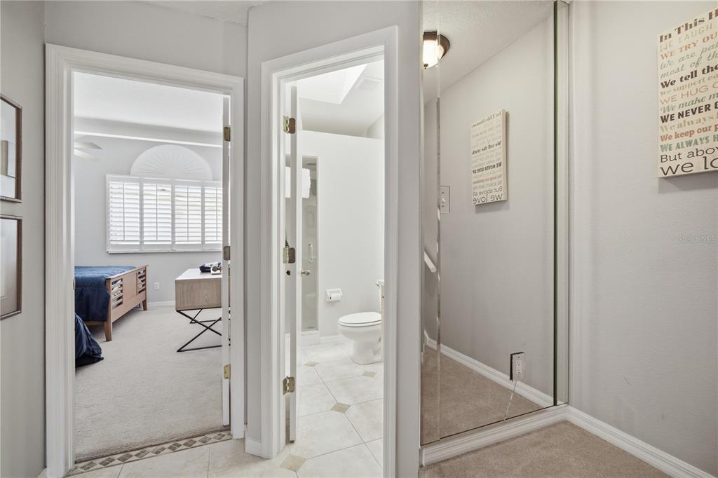643 Garland Circle Indian Rocks Beach, FL 33785 - Photo 27 of 81 a bathroom with a glass shower door and a mirror