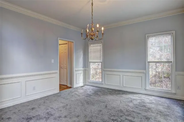 a view of an empty room with window and cabinet