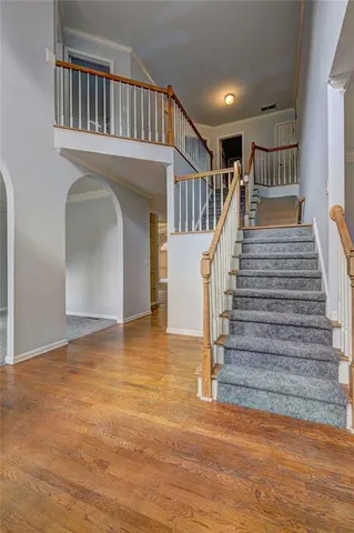 a view of entryway and hall with wooden floor