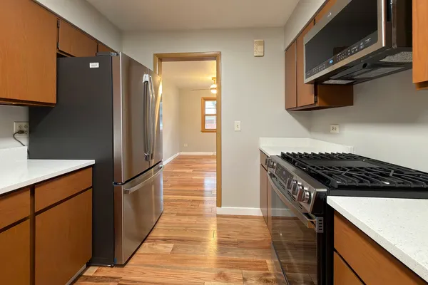 a kitchen with stainless steel appliances granite countertop a refrigerator and a sink