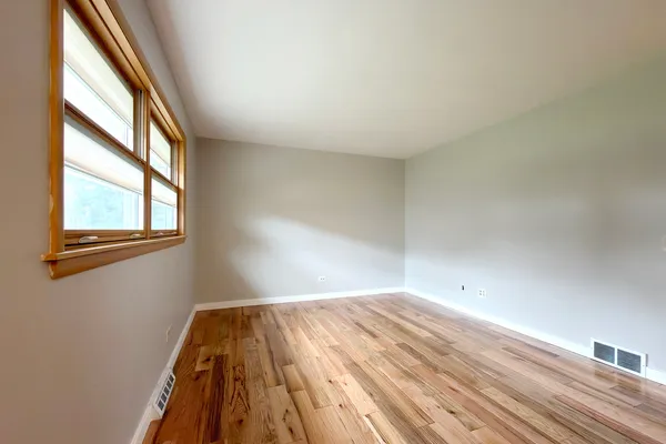a view of a room with wooden floor and windows