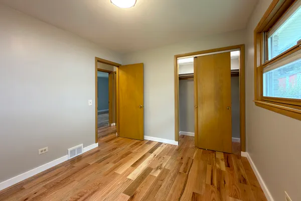 a view of a room with wooden floor and sliding door