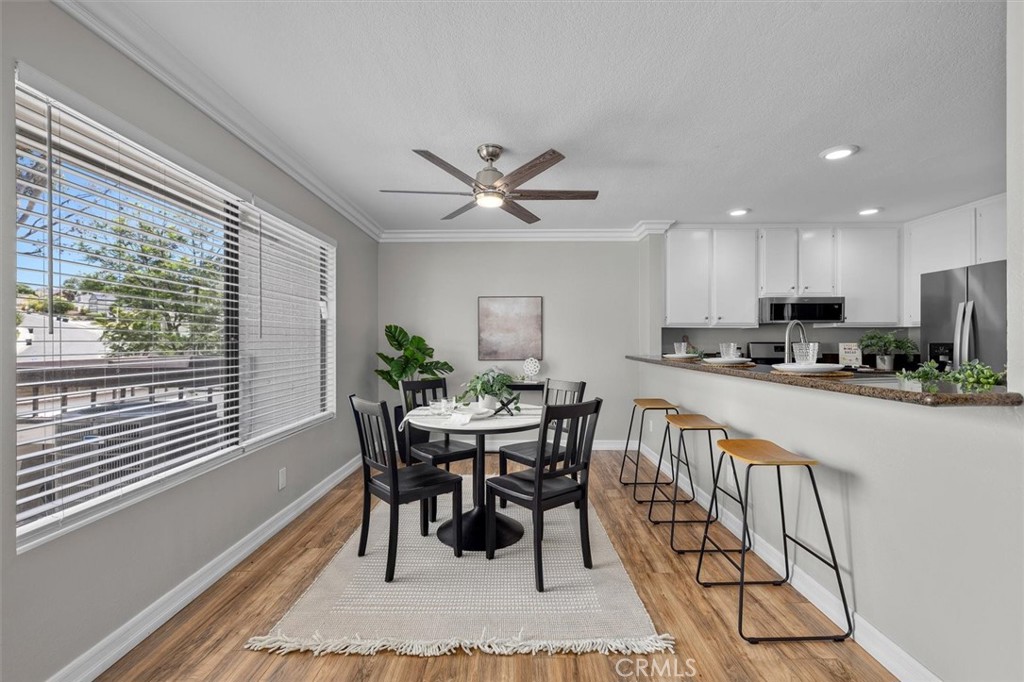 22206 Rim Pointe, Unit 7G Lake Forest, CA 92630 - Photo 12 of 39 a view of a dining room with furniture window and wooden floor