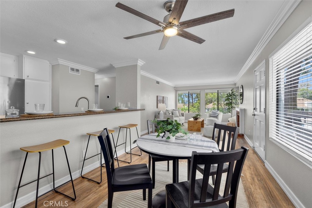 22206 Rim Pointe, Unit 7G Lake Forest, CA 92630 - Photo 14 of 39 a view of a dining room with furniture window and wooden floor