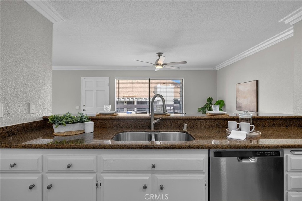 22206 Rim Pointe, Unit 7G Lake Forest, CA 92630 - Photo 17 of 39 a kitchen with granite countertop a sink and white cabinets