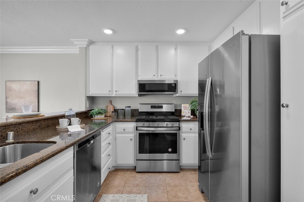 22206 Rim Pointe, Unit 7G Lake Forest, CA 92630 - Photo 18 of 39 a kitchen with a sink stove and refrigerator