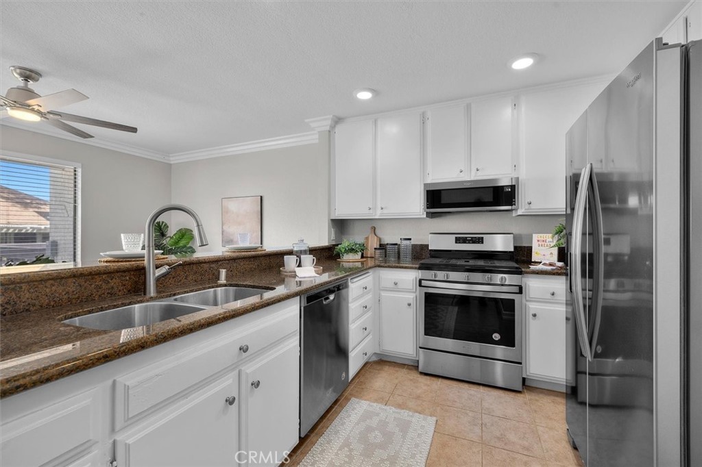 22206 Rim Pointe, Unit 7G Lake Forest, CA 92630 - Photo 19 of 39 a kitchen with stainless steel appliances granite countertop a sink stove and refrigerator