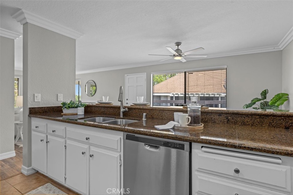 22206 Rim Pointe, Unit 7G Lake Forest, CA 92630 - Photo 20 of 39 a kitchen with a sink a window and cabinets