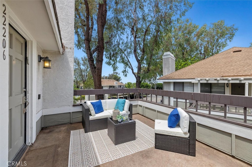 22206 Rim Pointe, Unit 7G Lake Forest, CA 92630 - Photo 2 of 39 a view of a patio with couches table and chairs and potted plants
