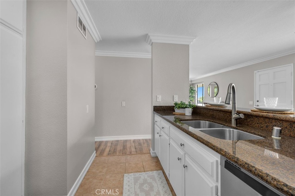 22206 Rim Pointe, Unit 7G Lake Forest, CA 92630 - Photo 21 of 39 a kitchen with granite countertop a sink and a granite counter tops
