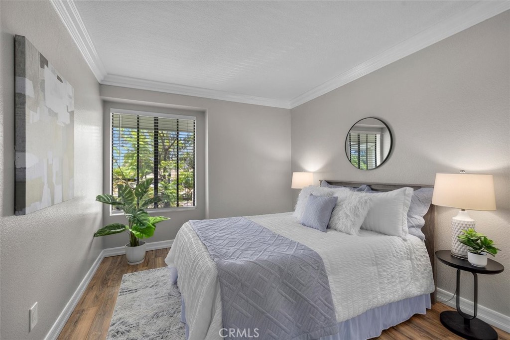22206 Rim Pointe, Unit 7G Lake Forest, CA 92630 - Photo 23 of 39 a bedroom with a bed and window