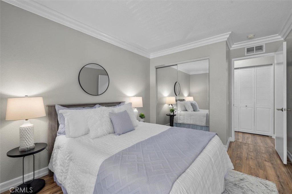 22206 Rim Pointe, Unit 7G Lake Forest, CA 92630 - Photo 24 of 39 a bedroom with a bed and a lamp