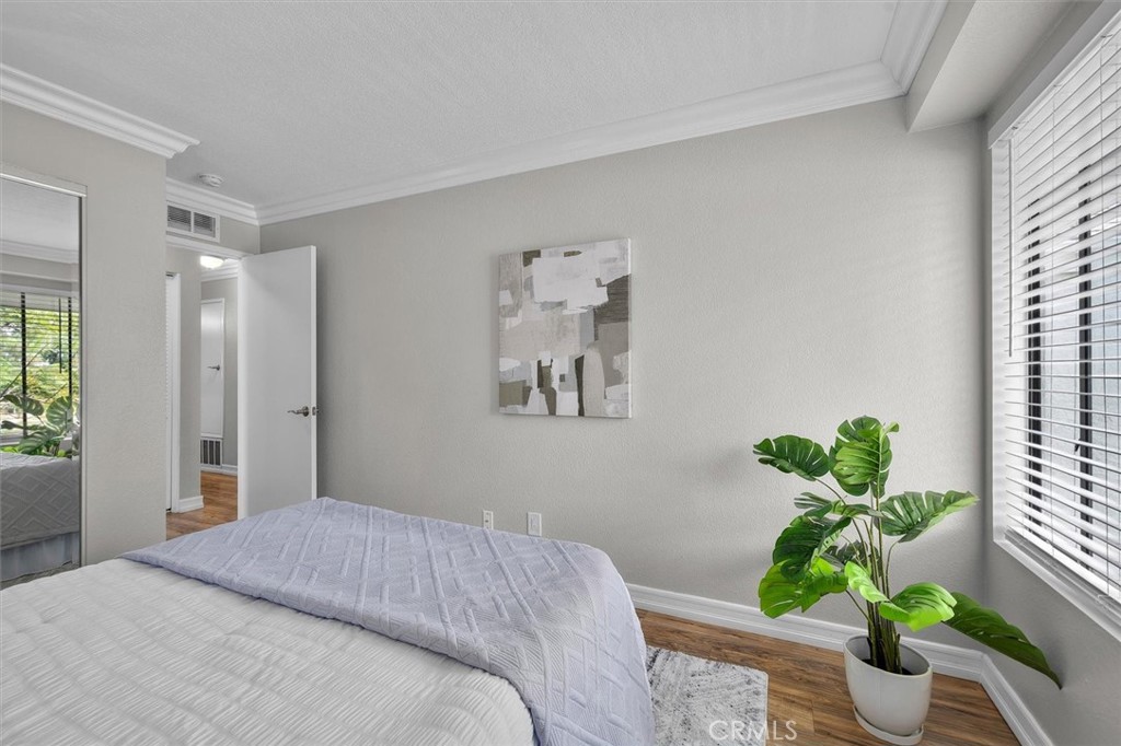 22206 Rim Pointe, Unit 7G Lake Forest, CA 92630 - Photo 25 of 39 a bedroom with a bed potted plant and a window