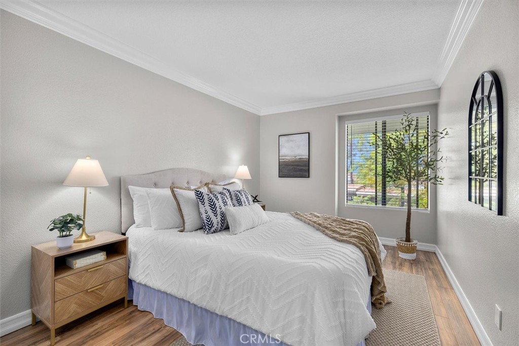 22206 Rim Pointe, Unit 7G Lake Forest, CA 92630 - Photo 26 of 39 a bed room with a bed and a lamp