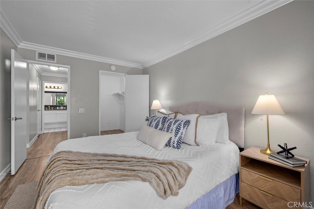 22206 Rim Pointe, Unit 7G Lake Forest, CA 92630 - Photo 28 of 39 a bedroom with a bed and a lamp