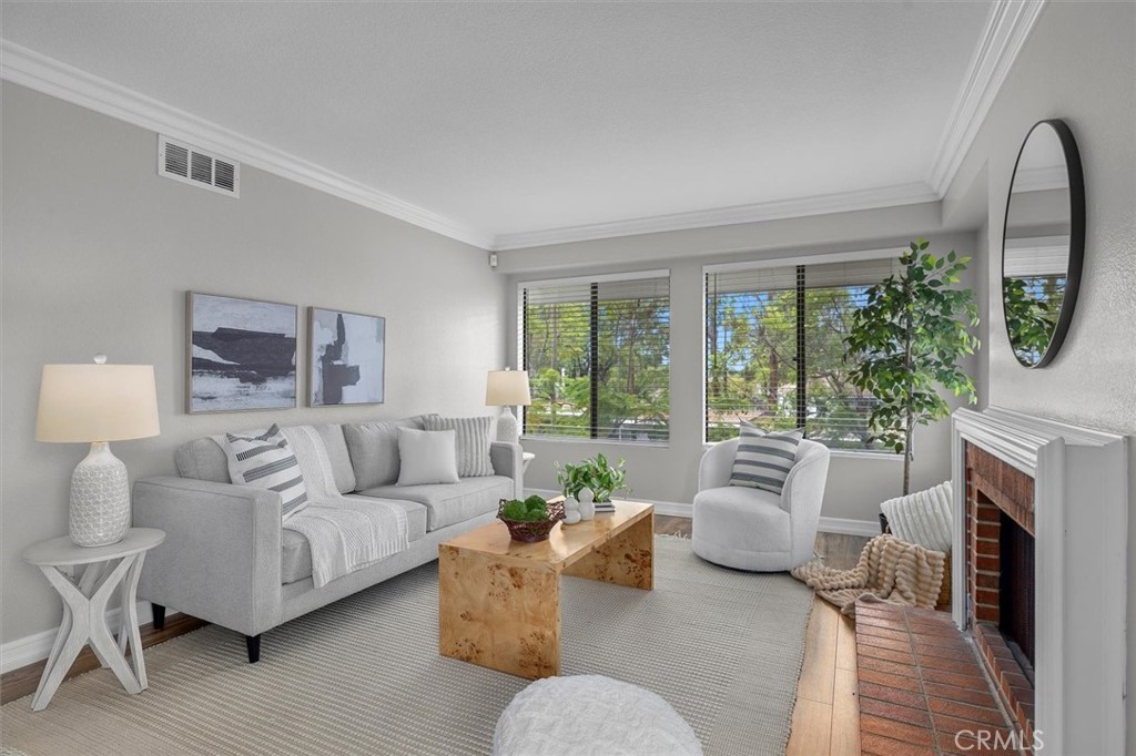 22206 Rim Pointe, Unit 7G Lake Forest, CA 92630 - Photo 5 of 39 a living room with furniture a fireplace and a large window