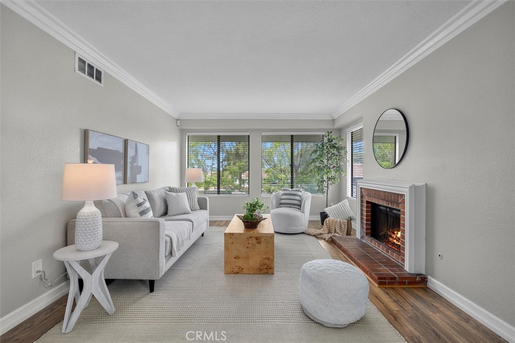 22206 Rim Pointe, Unit 7G Lake Forest, CA 92630 - Photo 6 of 39 a living room with furniture and a fireplace