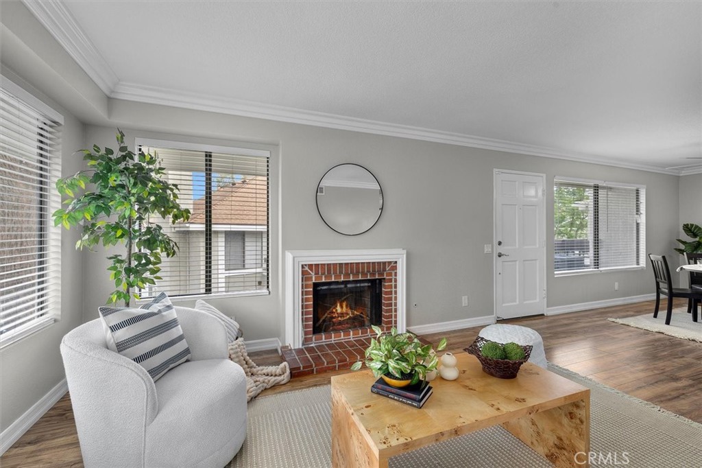 22206 Rim Pointe, Unit 7G Lake Forest, CA 92630 - Photo 7 of 39 a living room with furniture a fireplace and a potted plant