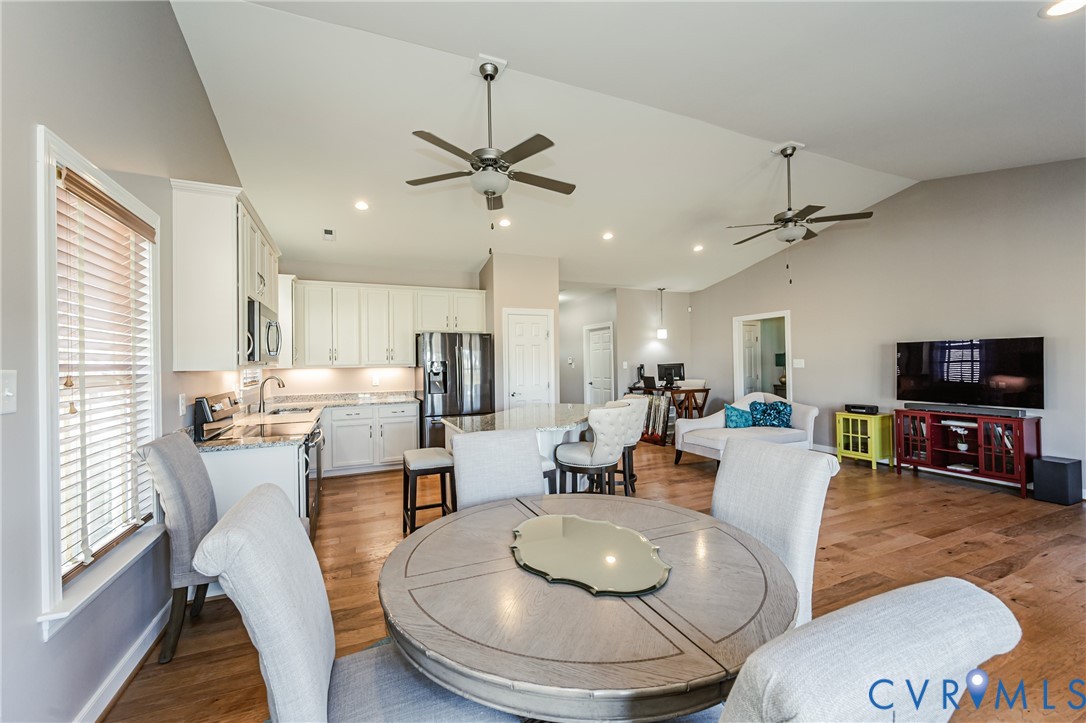 7622 Settlers Ridge Court Henrico, VA 23231 - Photo 12 of 43 a living room with stainless steel appliances furniture a fireplace and a flat screen tv