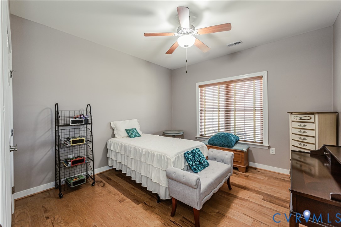 7622 Settlers Ridge Court Henrico, VA 23231 - Photo 28 of 43 a bedroom with a bed and a chandelier