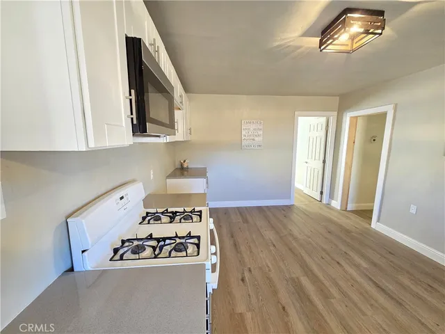 a kitchen with a stove and a microwave