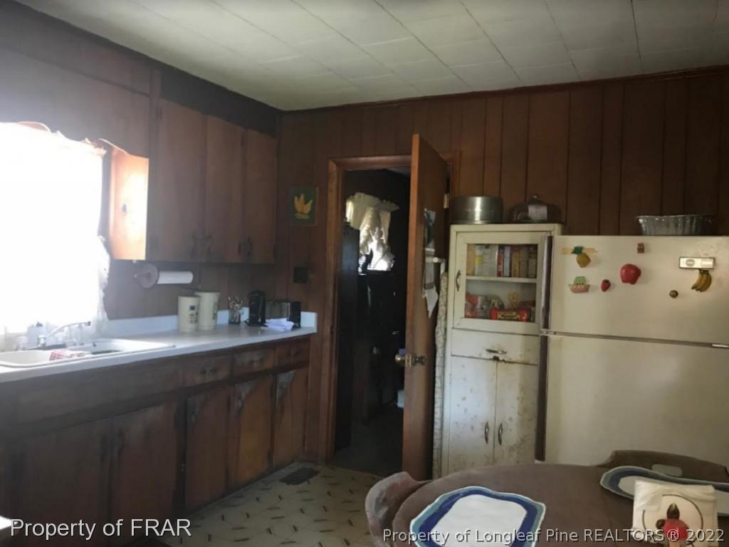 7414 Burnett Road Godwin, NC 28344 - Photo 7 of 9 a kitchen with a refrigerator and sink